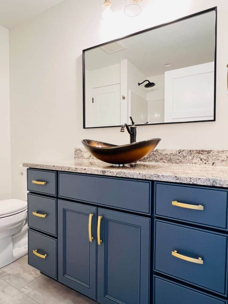 bathroom with blue cabinets