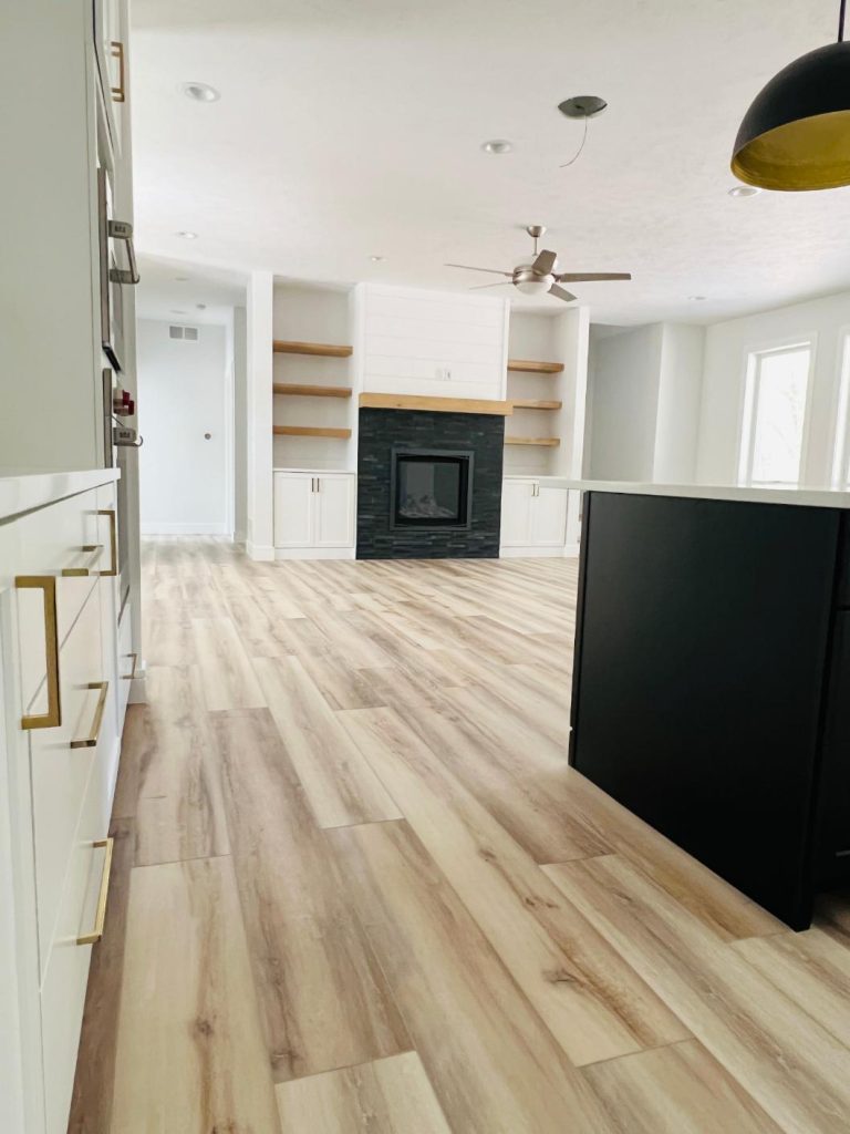 open living, wood floors, custom tiled fireplace