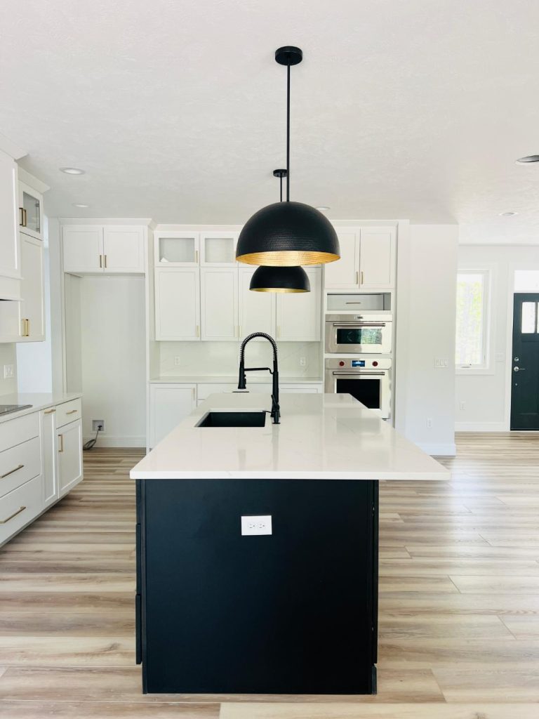 Kitchen island with white counter and black base.