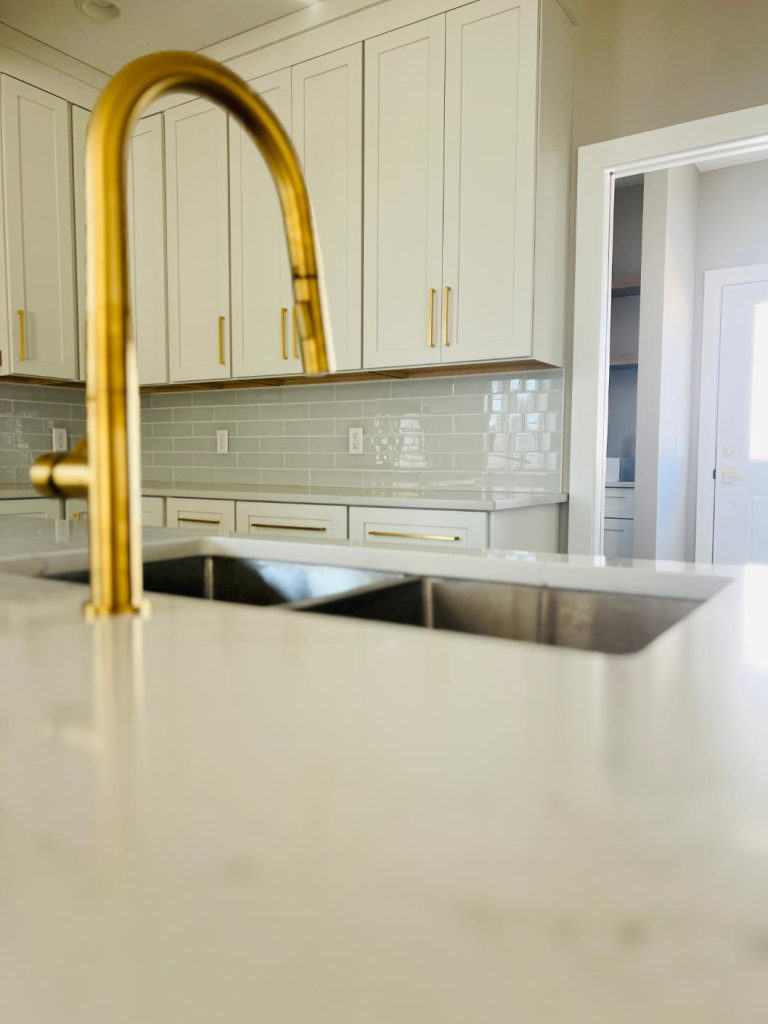 kitchen sink with gold faucet